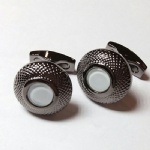 Cufflink with shell